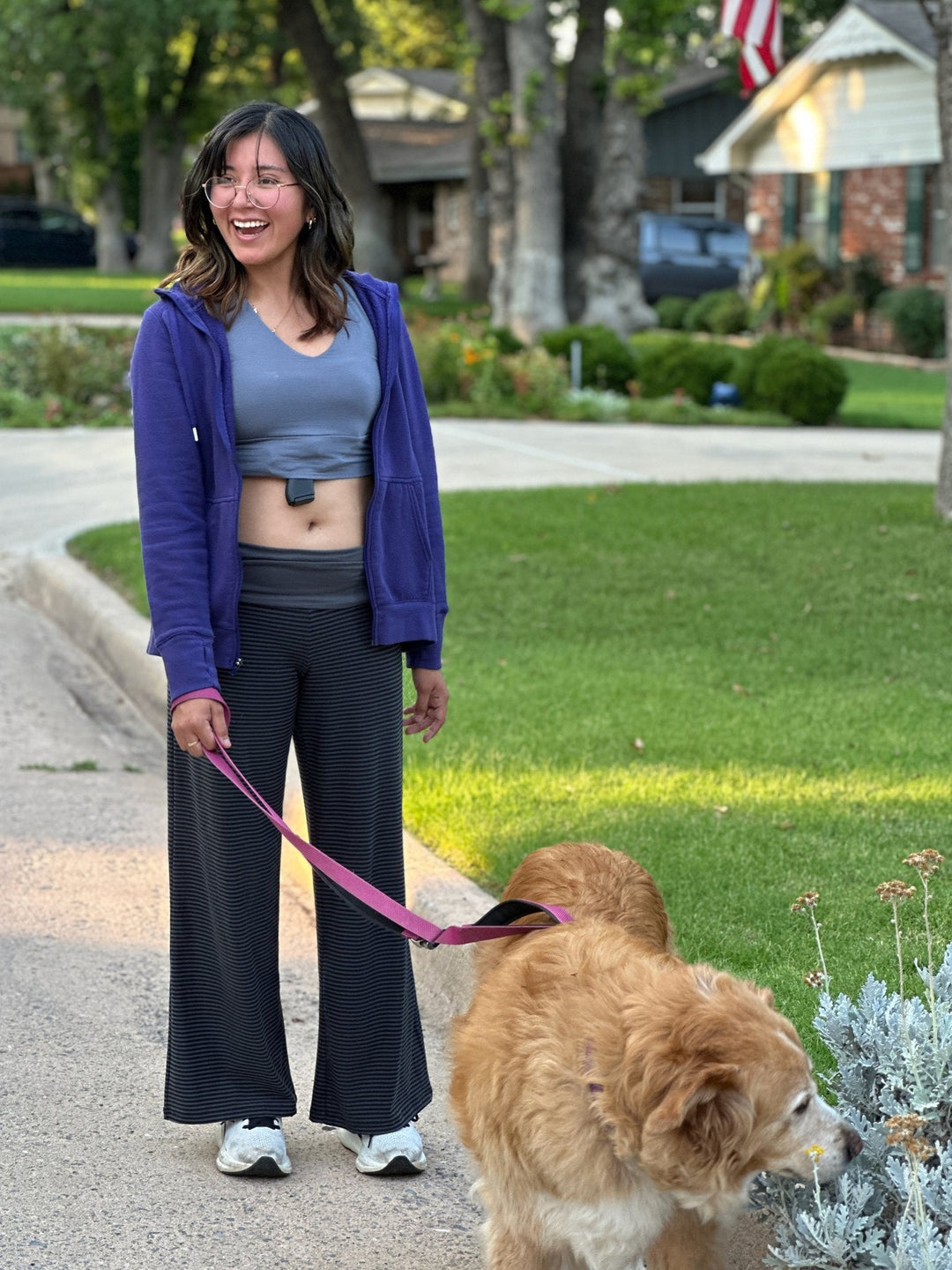 Woman wearing a Flashbang bra holster while walking her dog — everyday concealed carry comfort
