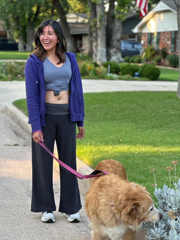 Woman wearing a Flashbang bra holster while walking her dog — everyday concealed carry comfort