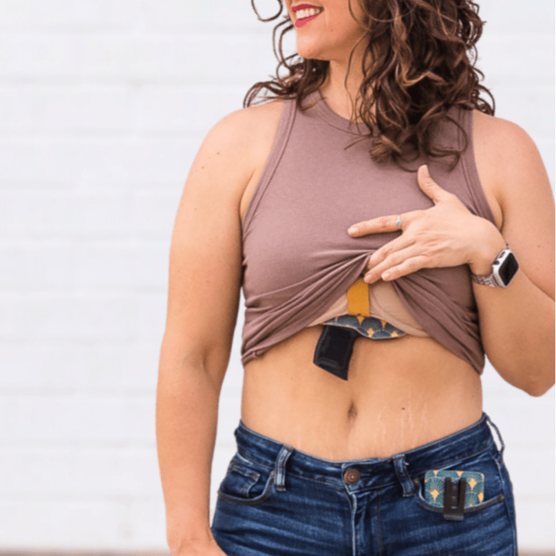 Woman wearing the Flashbang Bra Holster  and smiling #flashbang-color_royal-purple