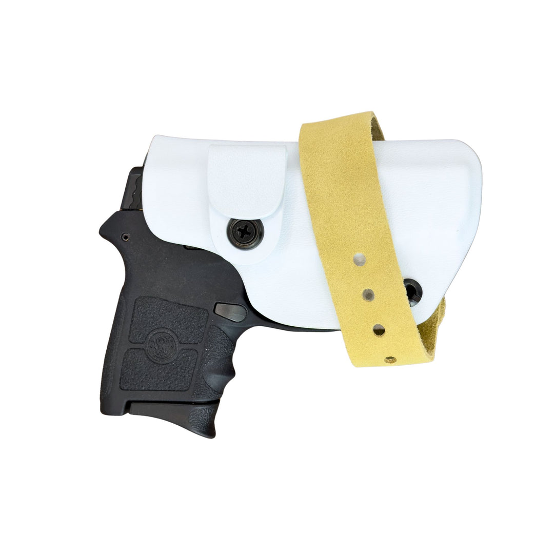 Black handgun with white holster and gold strap on a white background