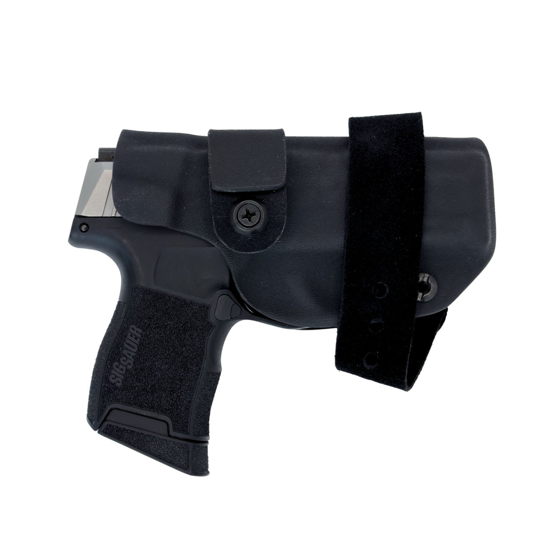 Black handgun and holster set on a white background