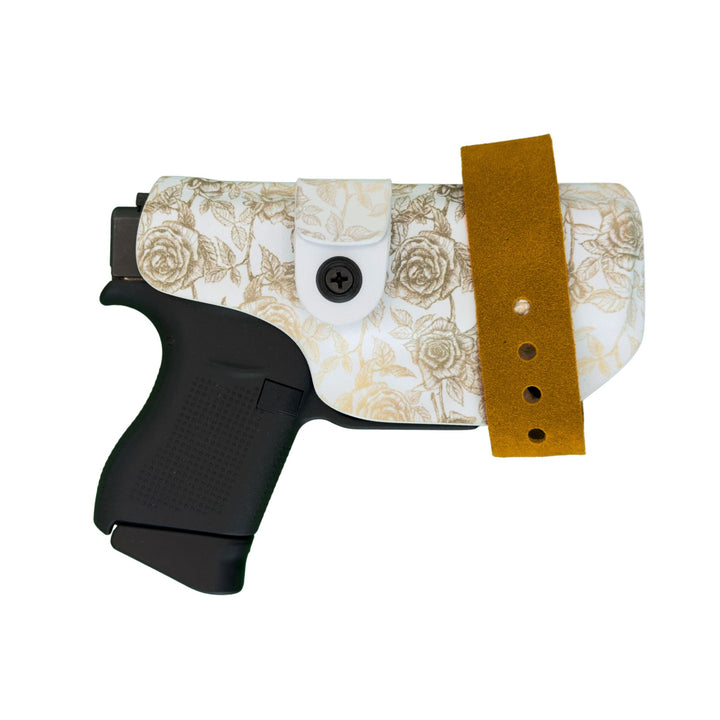 Floral-patterned gun holster with a brown strap on a white background